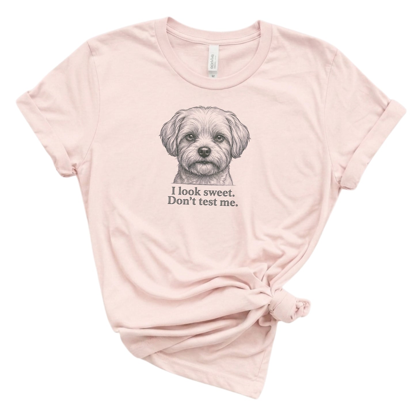Pink t-shirt with a dog graphic and text on a white background
