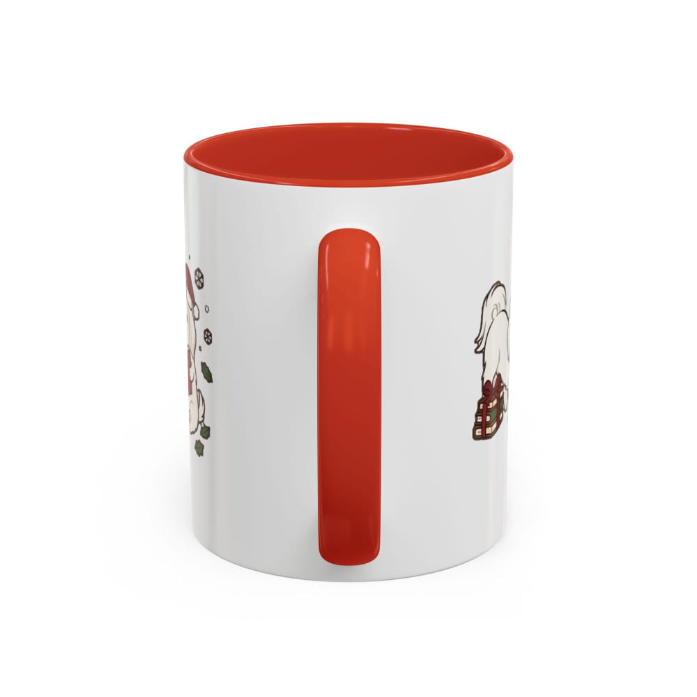 White ceramic mug with a red interior and red handle, back view with partial Maltese illustrations on either side of the handle.