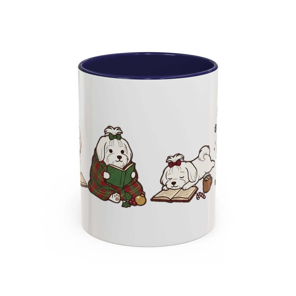 White ceramic mug with a navy interior, showing a Maltese in a plaid blanket reading a green book beside another Maltese lying on an open book.