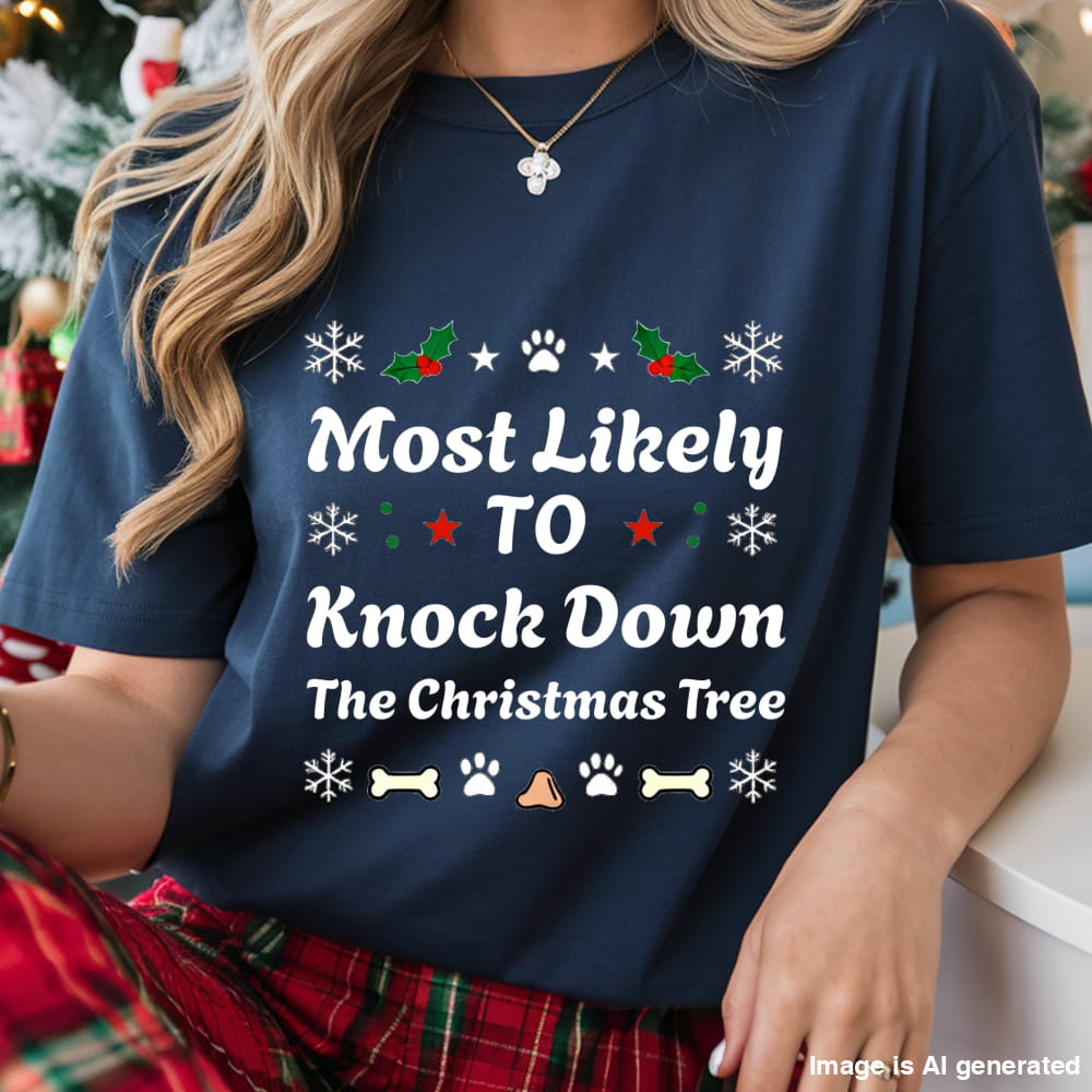 Navy blue t-shirt with Christmas-themed text and graphics worn by a person, with a festive background.