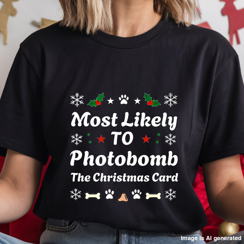 Black t-shirt with Christmas-themed text and graphics worn by a person.