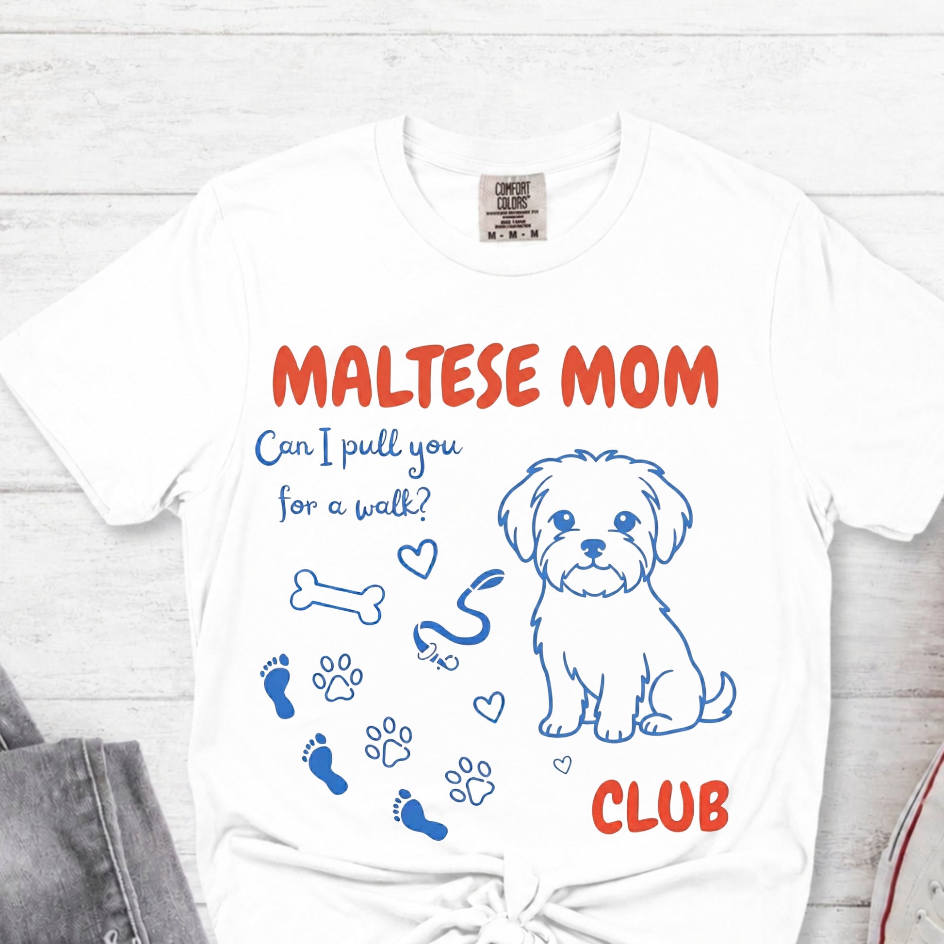 White t-shirt with 'Maltese Mom Club' design featuring a dog illustration on a white background.