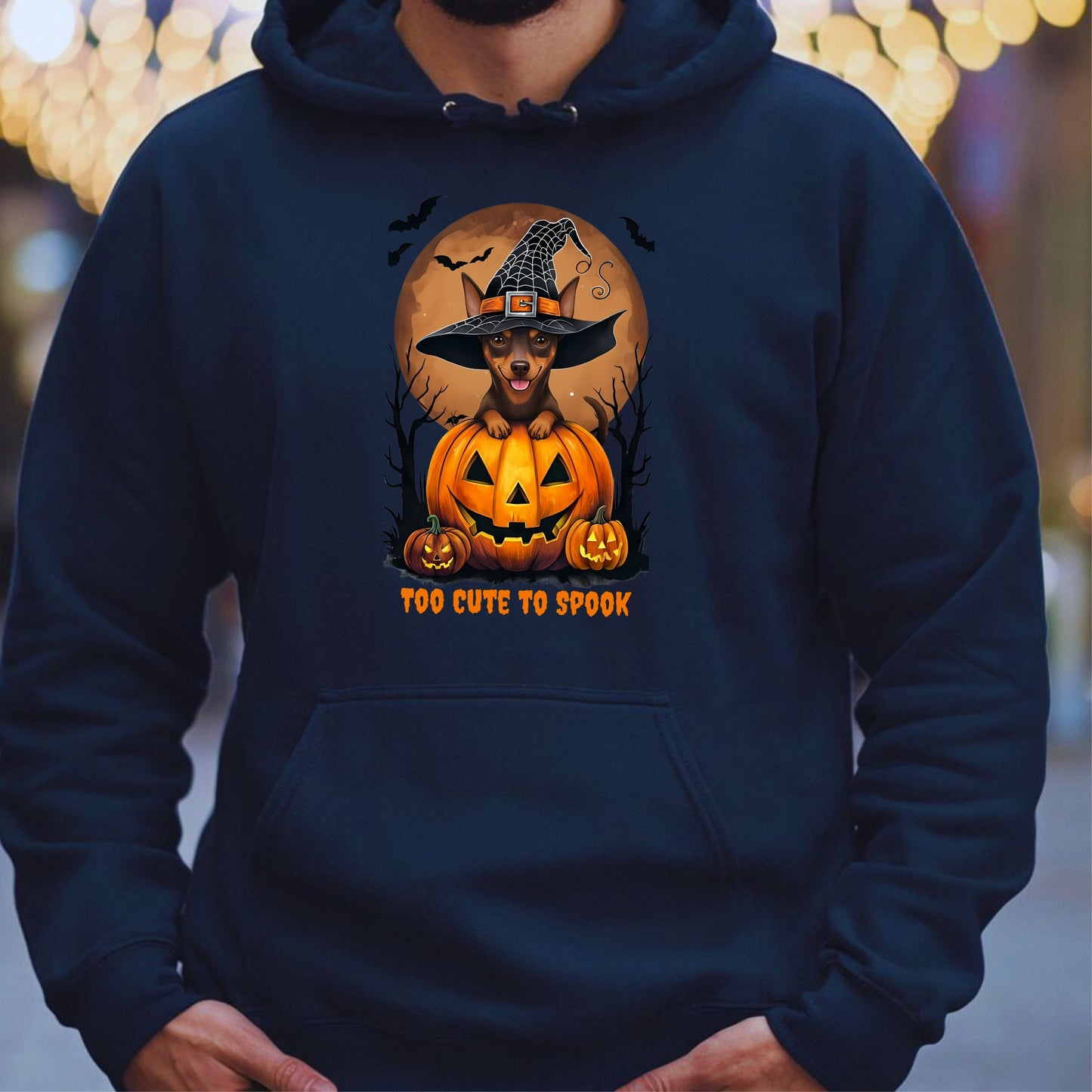 Navy blue hoodie with a Halloween-themed design featuring a dog in a witch hat on a pumpkin.