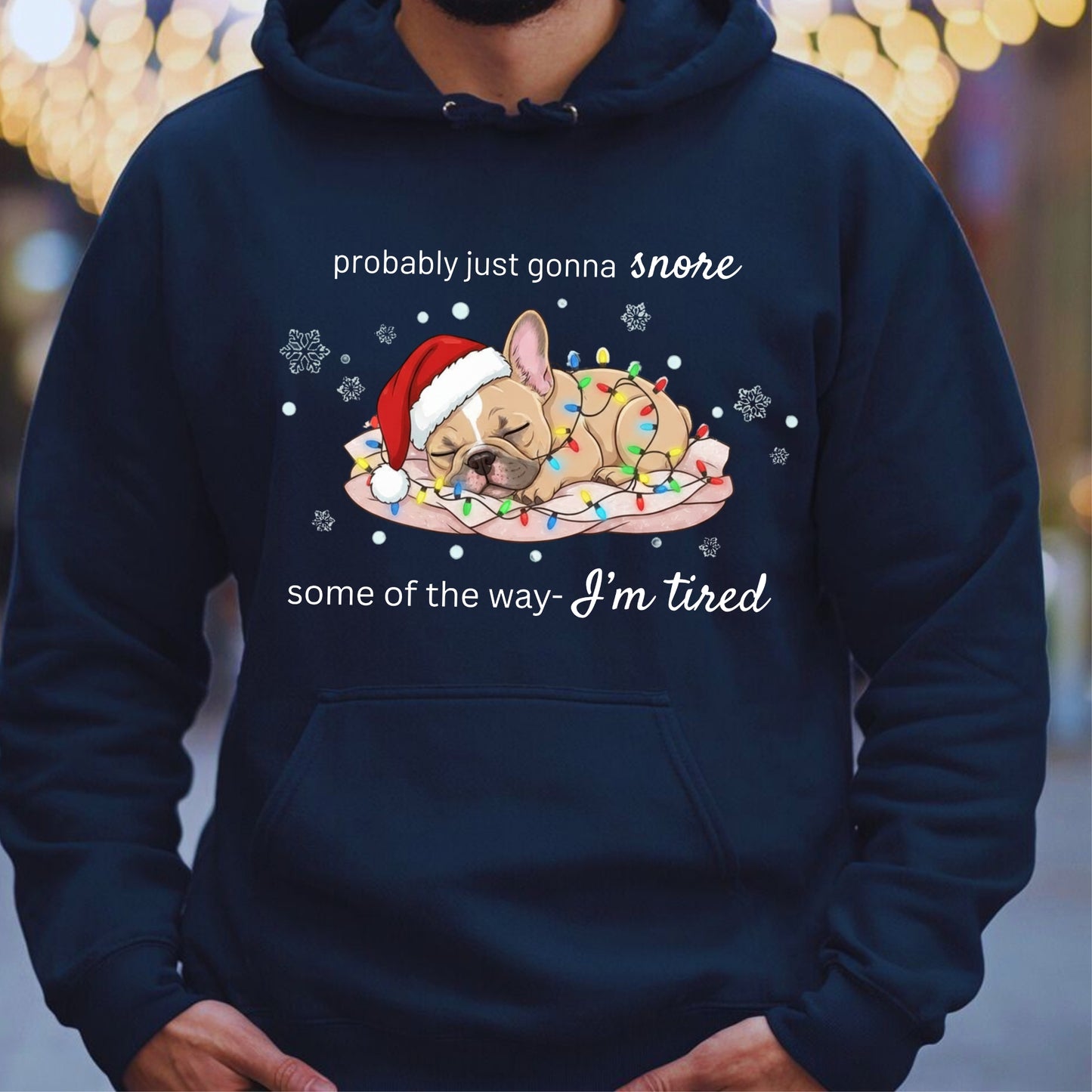Navy blue hoodie with a Christmas-themed graphic of a dog and text, worn by a person.