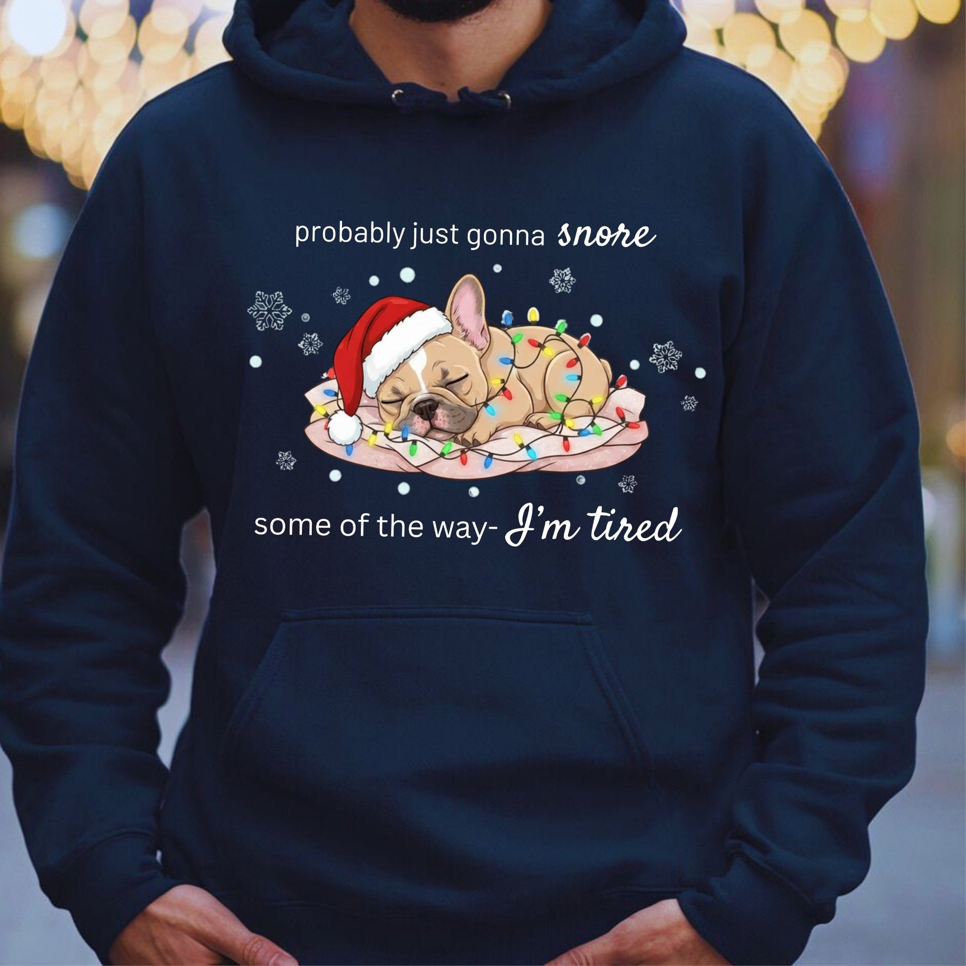 Navy blue hoodie with a Christmas-themed graphic of a dog and text, worn by a person.