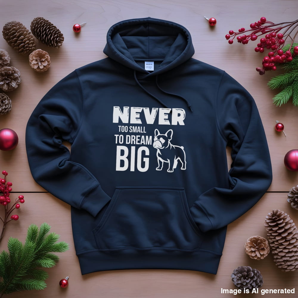 Navy blue hoodie with motivational text and dog graphic on a wooden surface with decorative elements.
