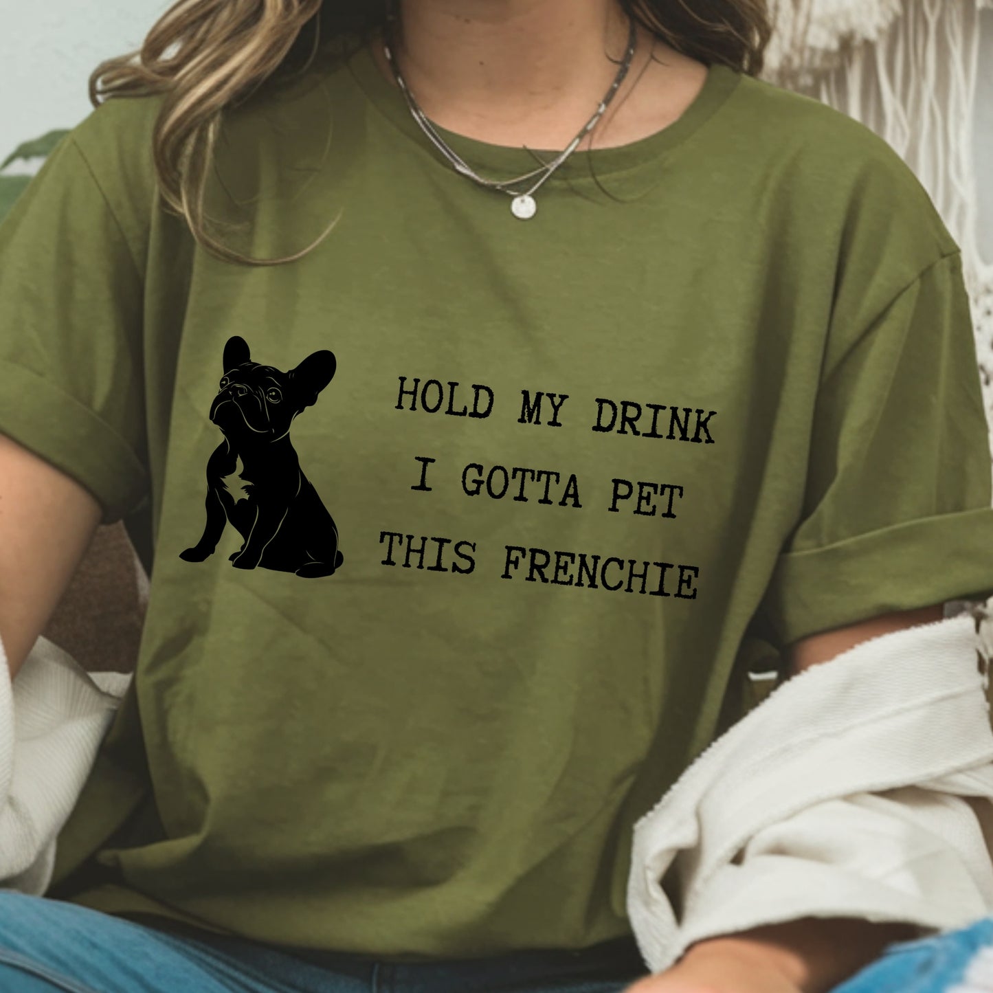Person wearing a green t-shirt with a dog graphic and text.