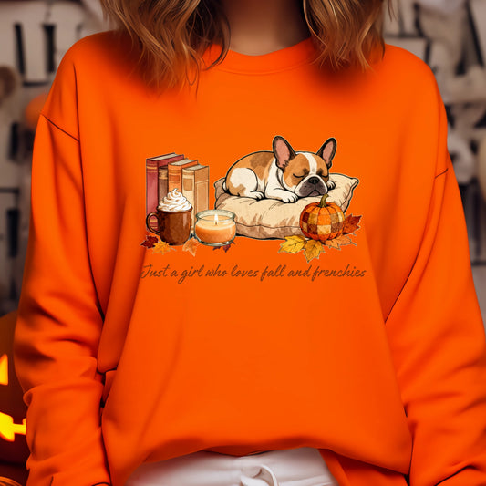 Orange sweatshirt with a graphic of a dog, books, coffee, and pumpkins on a blurred background