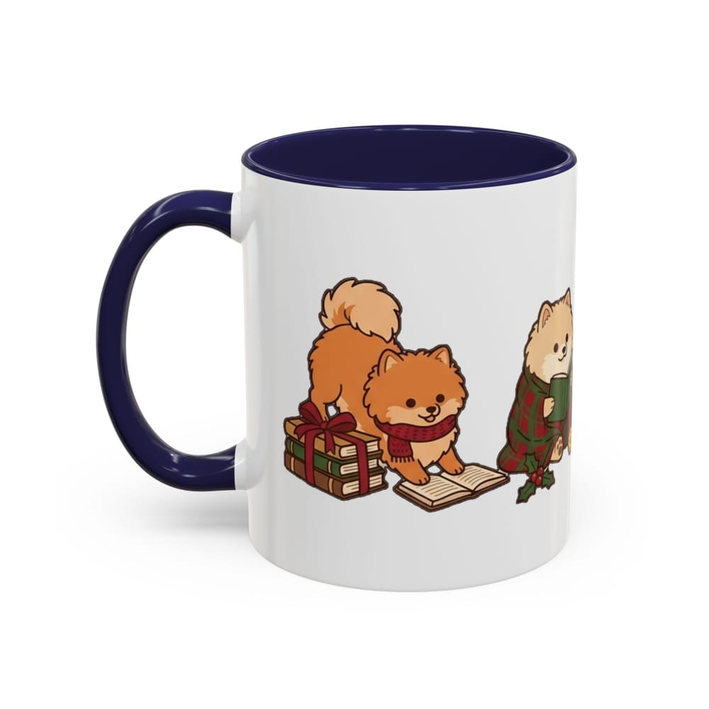 White ceramic mug with a navy interior and navy handle, showing an orange Pomeranian in a red scarf beside a wrapped gift and a cream Pomeranian in a plaid blanket.