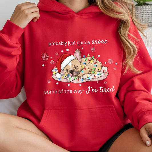 Red hoodie with a Christmas-themed design of a dog and text, held by a person.