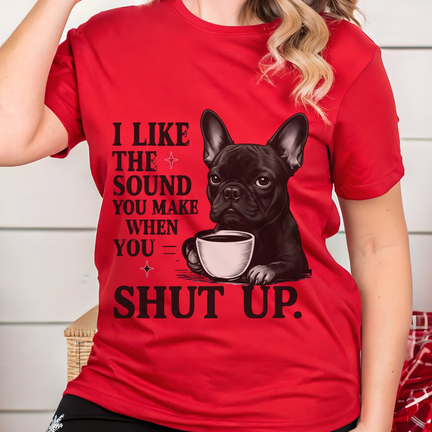 Person wearing a red t-shirt with a graphic of a dog holding a coffee cup and text.