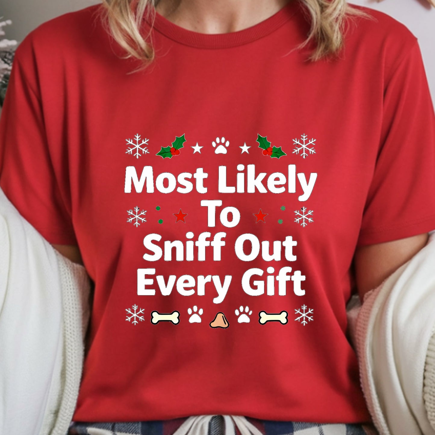 Red t-shirt with Christmas-themed text and graphics worn by a person.