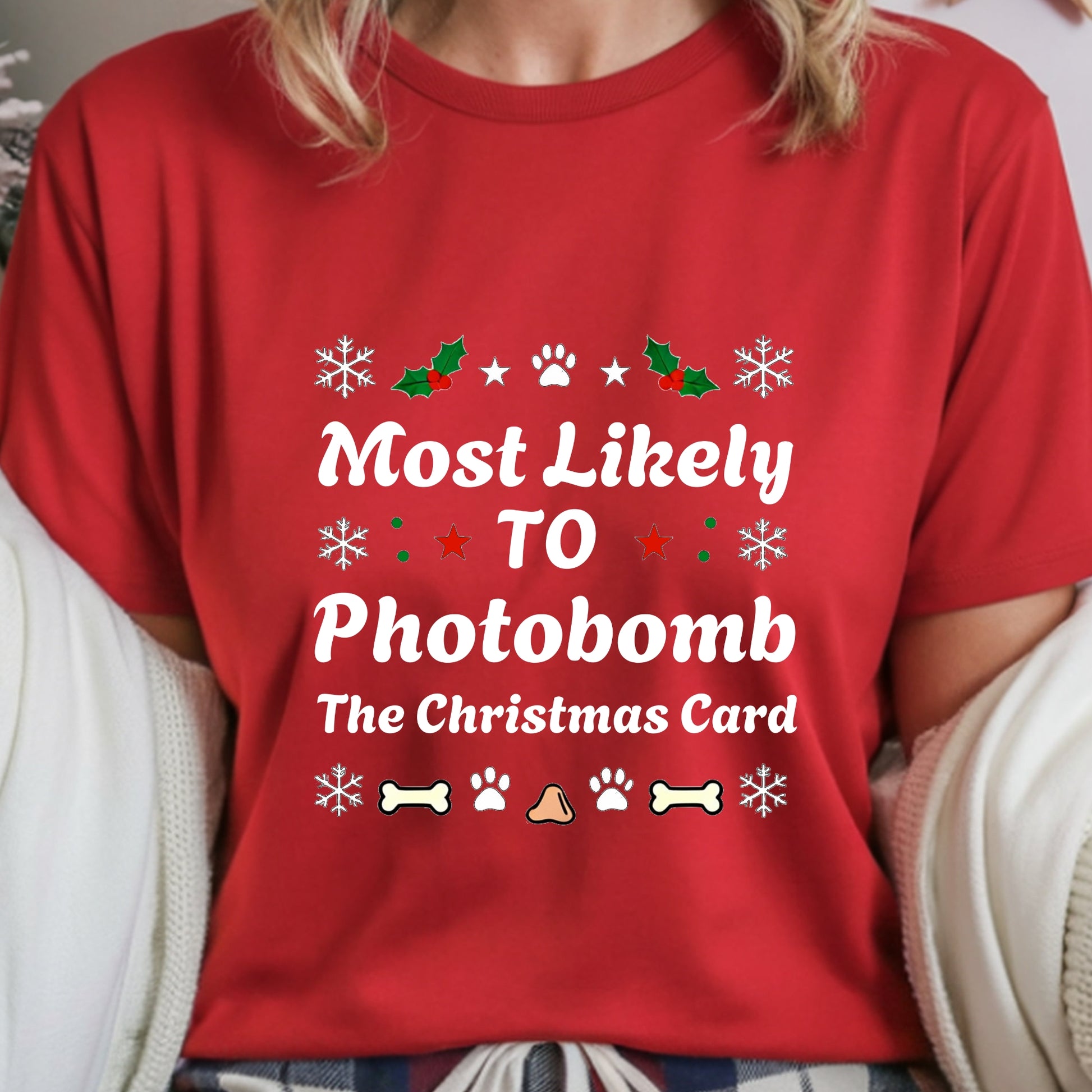 Red t-shirt with Christmas-themed text and graphics worn by a person.