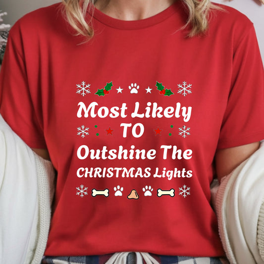 Red t-shirt with Christmas-themed text and graphics worn by a person.