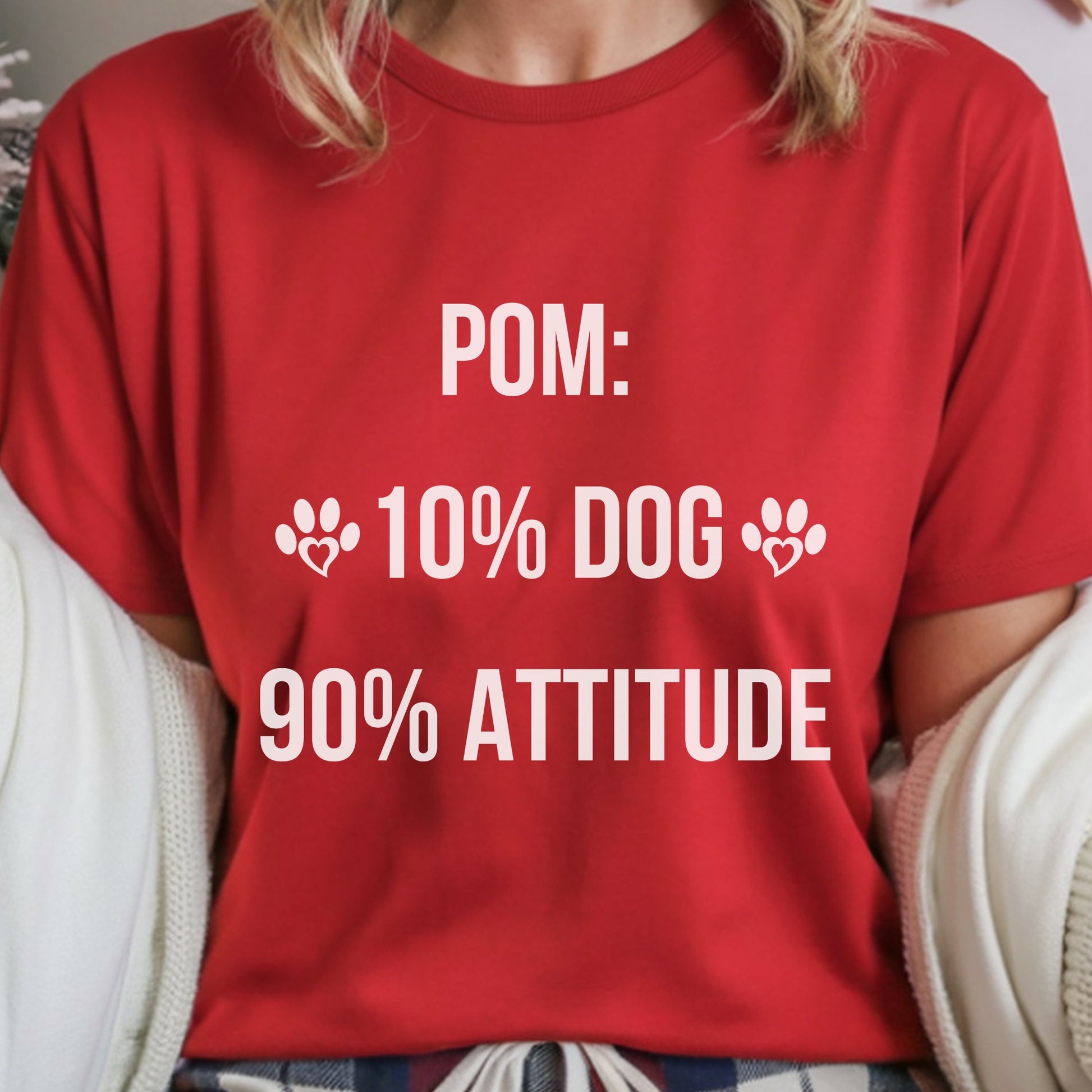 Red t-shirt with white text and paw prints worn by a person.