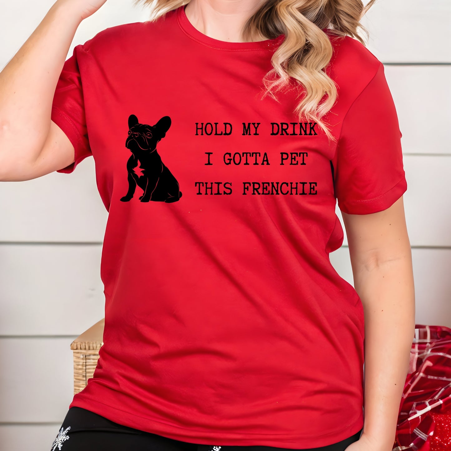 Person wearing a red t-shirt with a black dog silhouette and text.