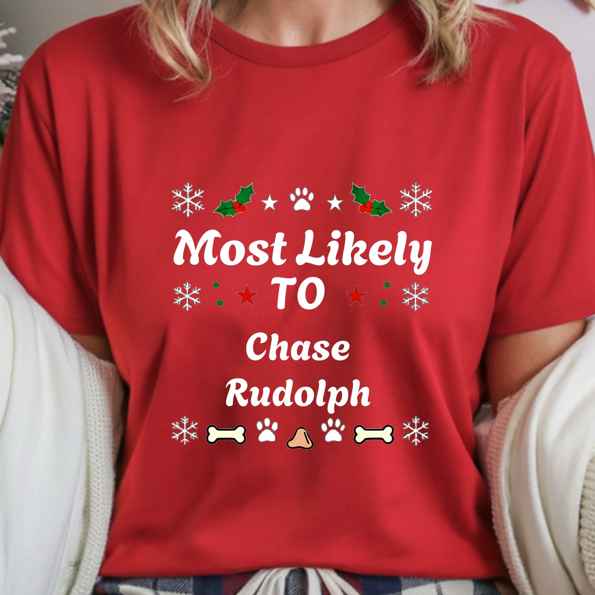 Red t-shirt with Christmas-themed text and graphics worn by a person.