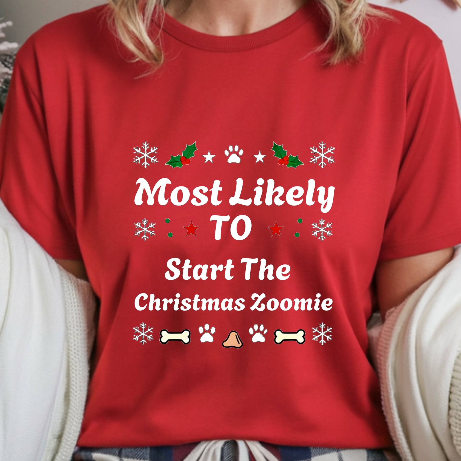 Red t-shirt with Christmas-themed text and graphics worn by a person.