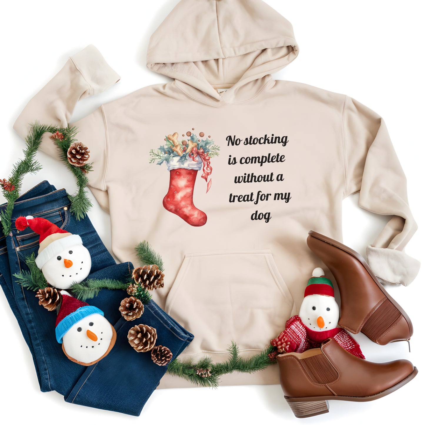 Beige hoodie with Christmas-themed design and festive items on a white background