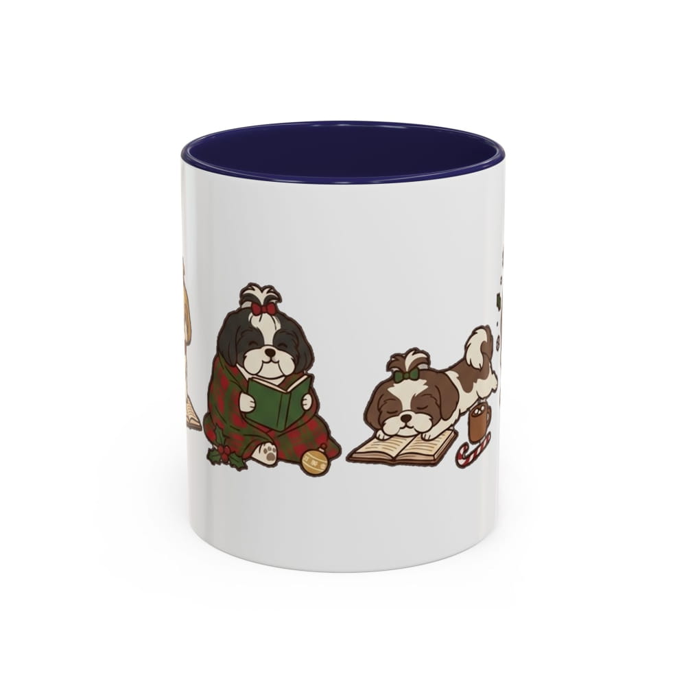White ceramic mug with a navy interior, showing a dark Shih Tzu in a plaid blanket reading a green book beside a brown-and-white Shih Tzu lying on an open book.