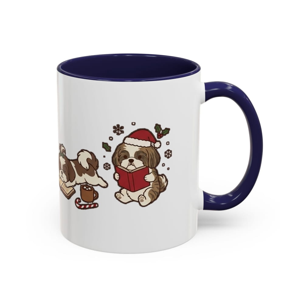 White ceramic mug with a navy interior and navy handle, showing a Shih Tzu in a Santa hat reading a red book, with another Shih Tzu beside a mug of cocoa.