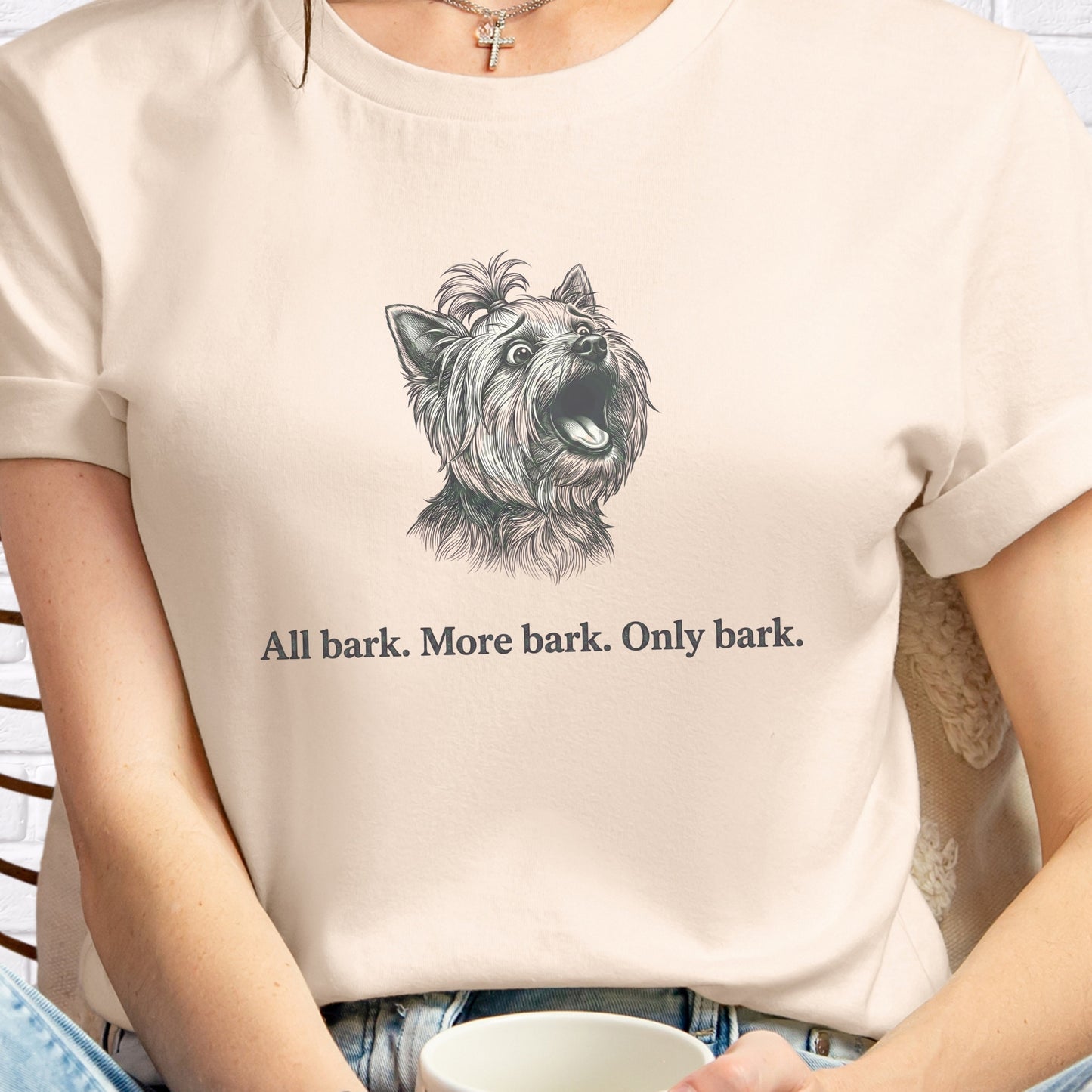 Person wearing a t-shirt with a dog graphic and text 'All bark. More bark. Only bark.'