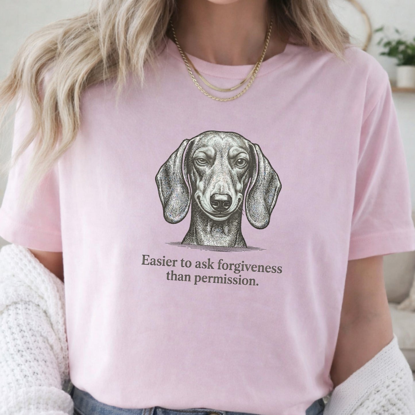Person wearing a pink t-shirt with a dachshund graphic and text.