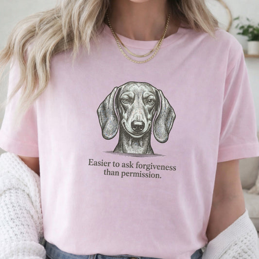 Person wearing a pink t-shirt with a dachshund graphic and text.