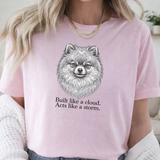 Person wearing a pink t-shirt with a dog illustration and text