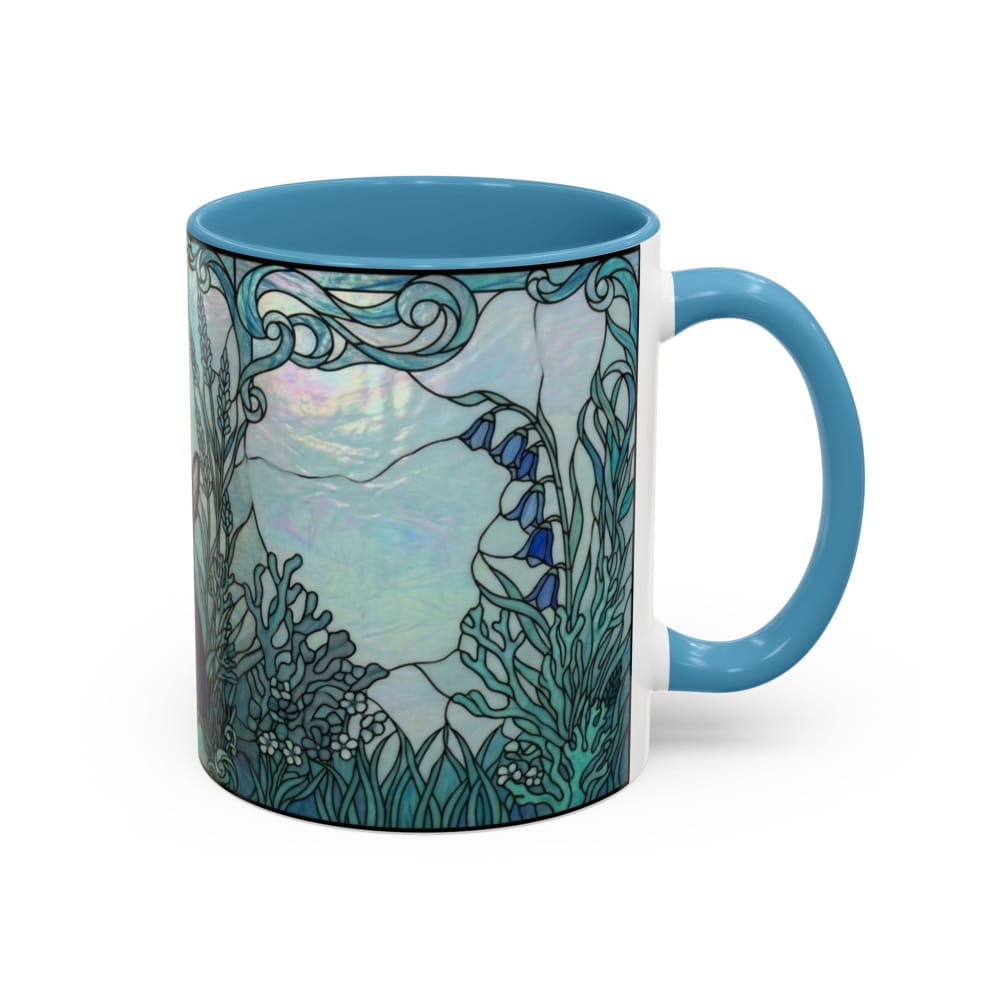 A ceramic mug with a blue handle and interior, featuring a stained-glass style illustration of an underwater scene with blue bells and sea plants on a white background.