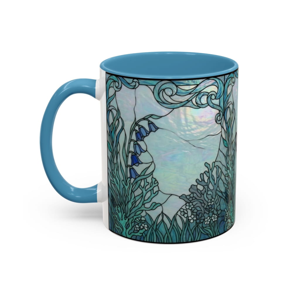 A ceramic mug with a turquoise blue handle and interior, featuring a detailed stained-glass style illustration of a coastal scene with blue bells, seaweed, and a pale sky on the exterior.