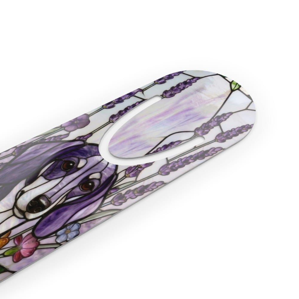 A close-up of a white curved product, likely a tool handle or decorative trim, featuring a stained-glass style illustration of a dog surrounded by purple lavender flowers and small colorful blossoms.