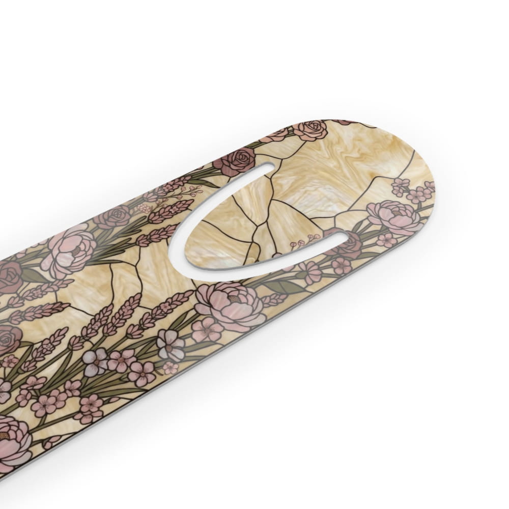 A close-up of a decorative product with a cream and beige marbled background and a floral pattern featuring pink roses, lavender, and green stems. A white oval cutout is visible on the surface.