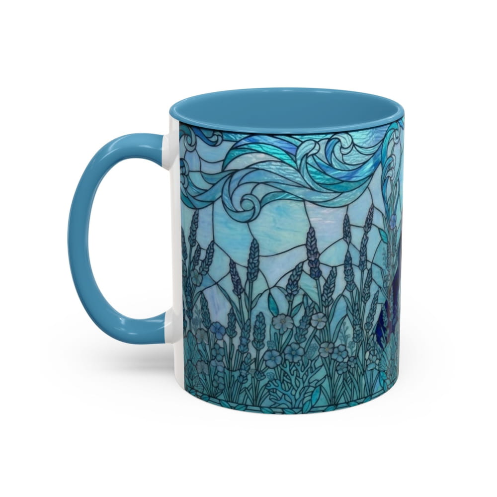 A ceramic mug with a blue handle and interior, featuring a stained-glass style illustration of lavender fields and blue waves on the exterior, shown on a white background.