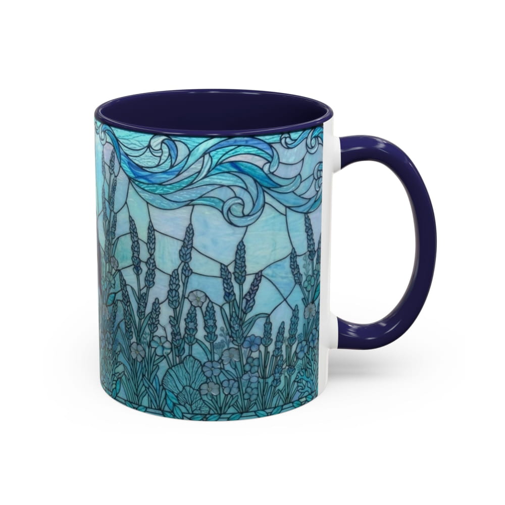 A ceramic mug with a dark navy blue handle and interior, featuring a stained-glass style illustration of blue and teal wildflowers and flowing sky on the exterior.