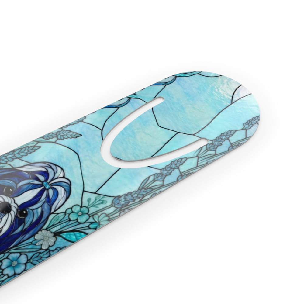 A close-up of a decorative product with a stained-glass-inspired design in shades of blue, featuring a stylized dog face and floral motifs, on a clean white background.