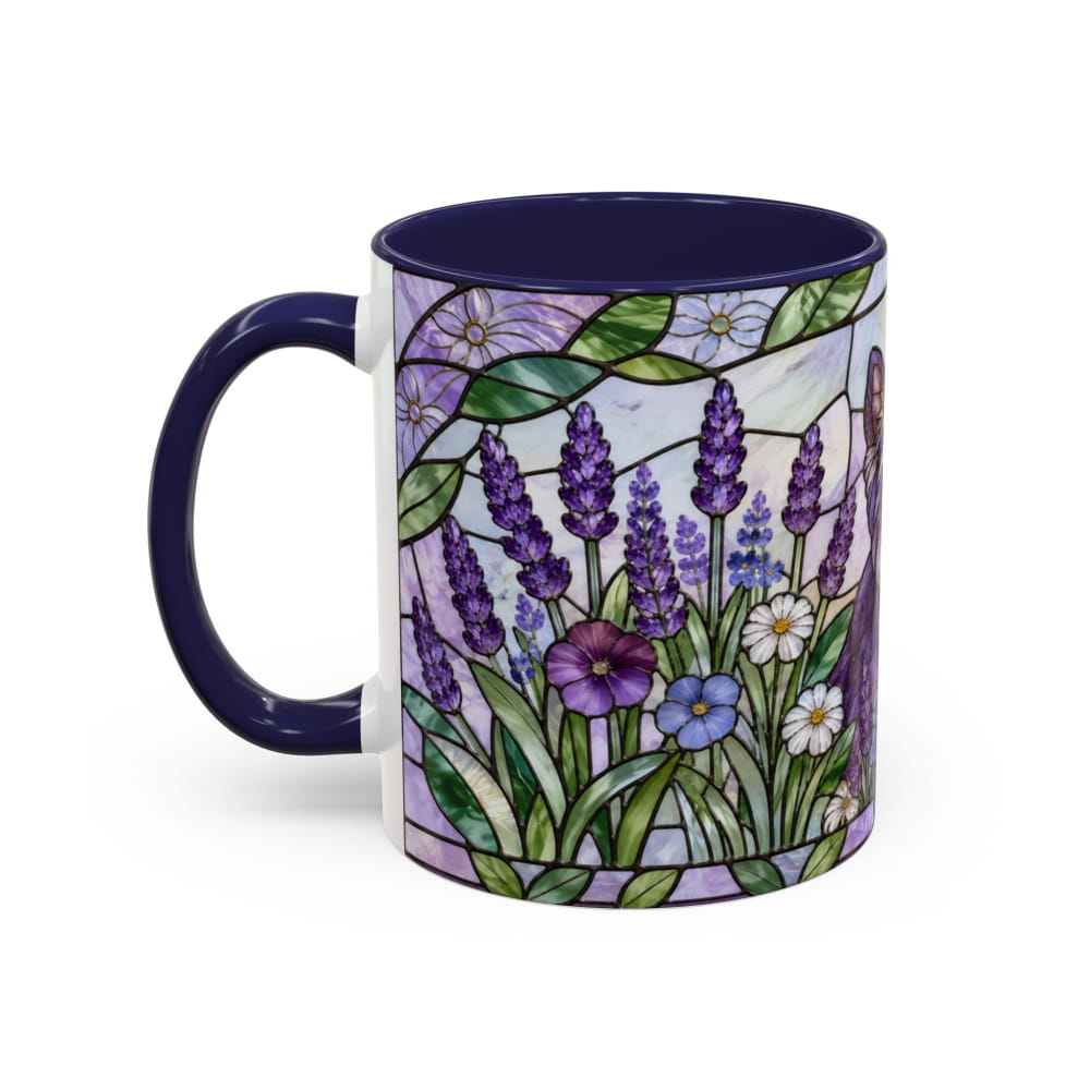 A ceramic mug with a dark navy blue handle and interior, featuring a stained-glass style floral design on the exterior with purple lavender, green leaves, and white and purple flowers.