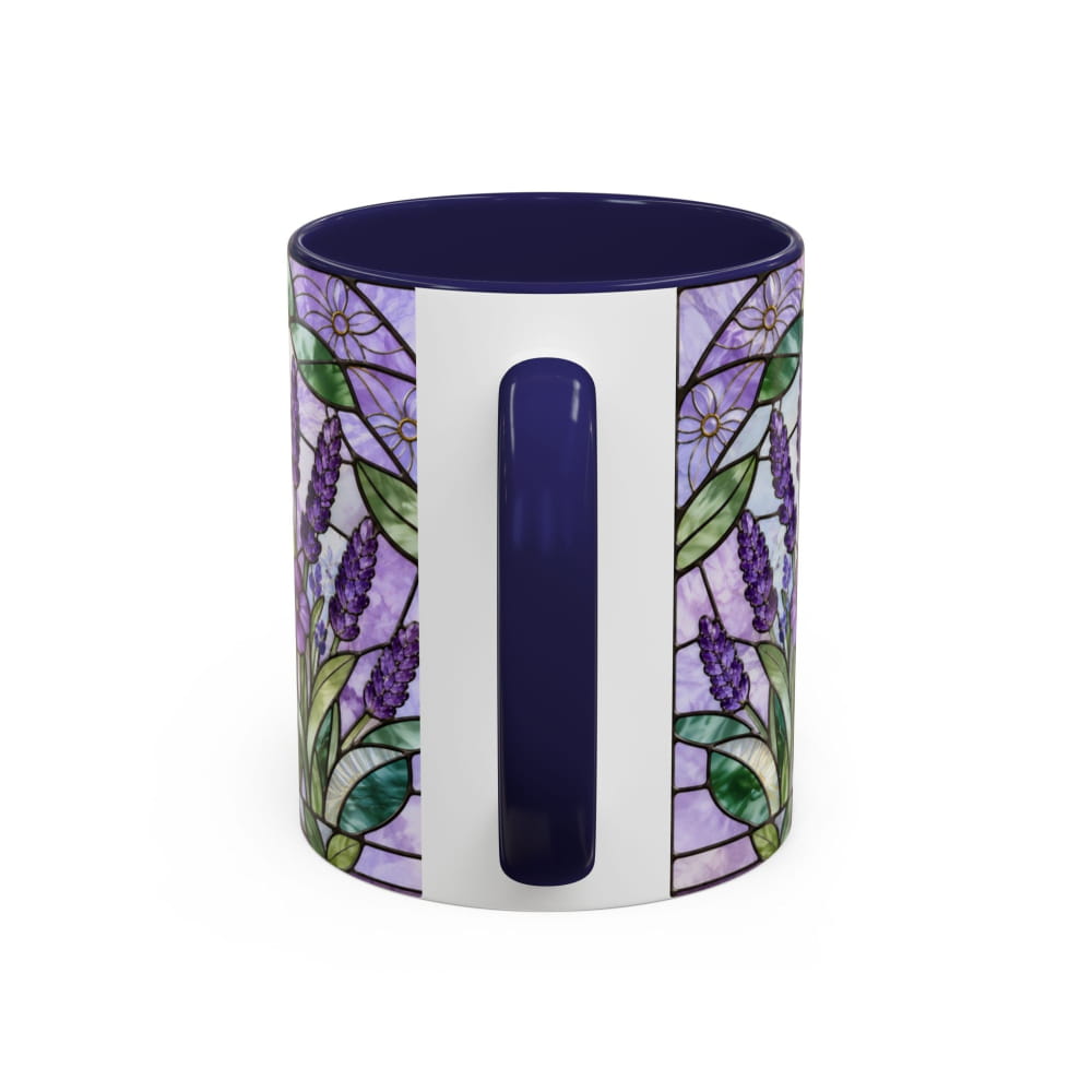 A ceramic mug featuring a stained-glass style floral pattern with purple flowers and green leaves on a white background, with a solid dark blue handle and interior.
