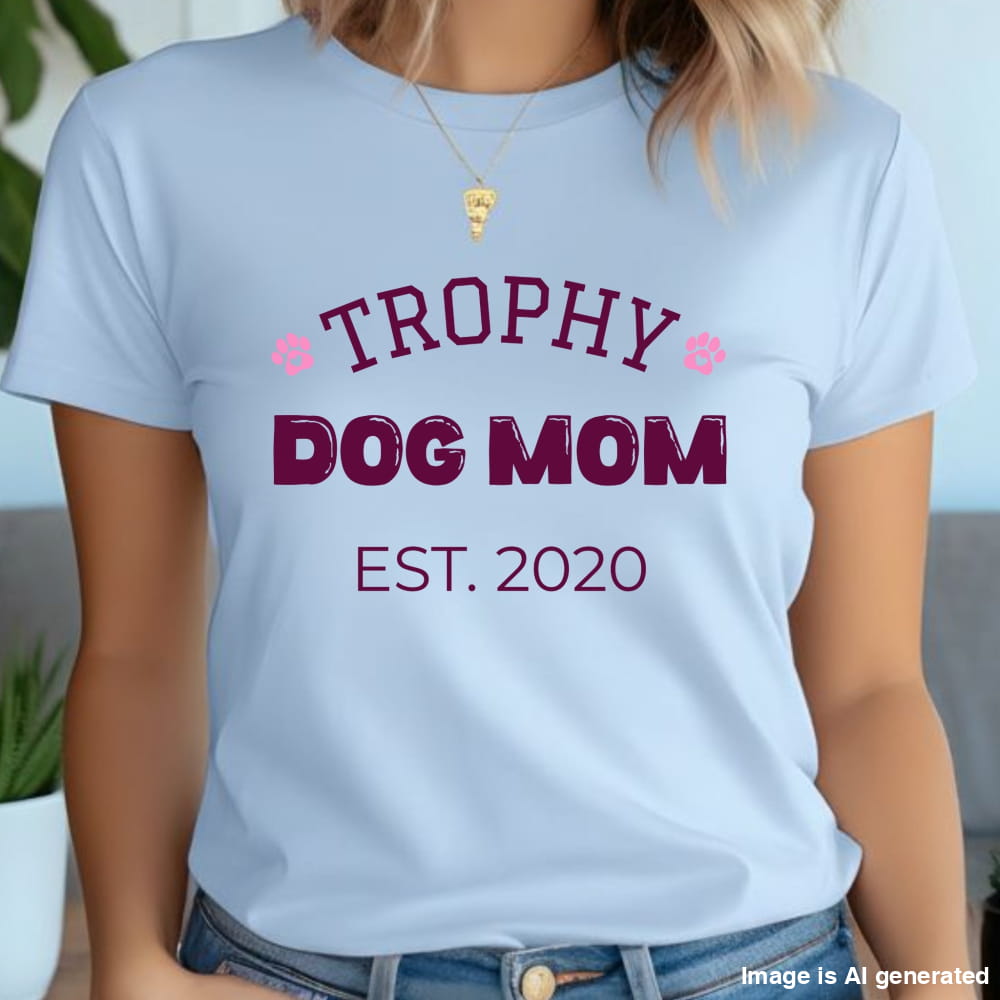 Light blue t-shirt with 'Trophy Dog Mom Est. 2020' text worn by a person.