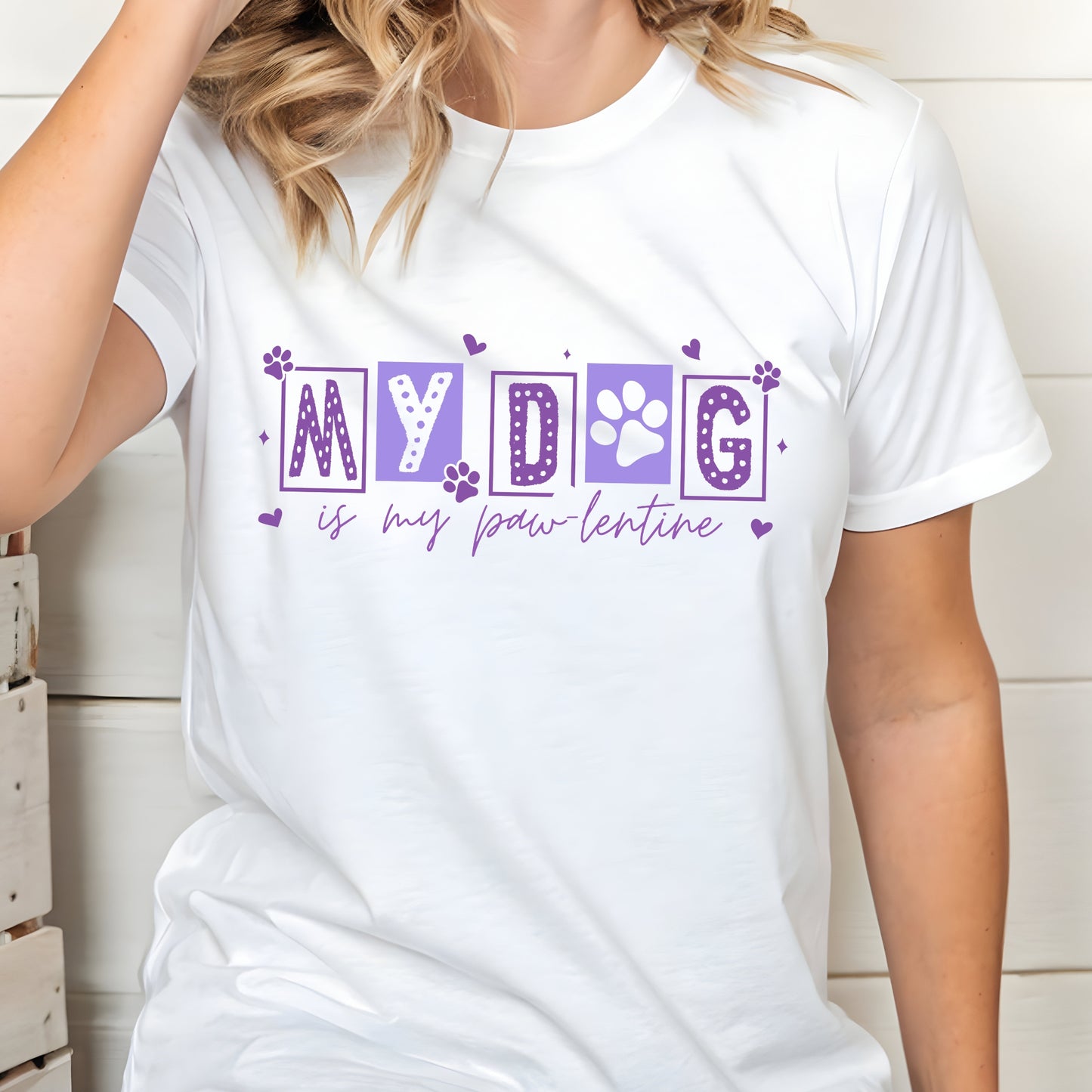 White t-shirt with purple text 'MY DOG is my paw lentine' worn by a person.