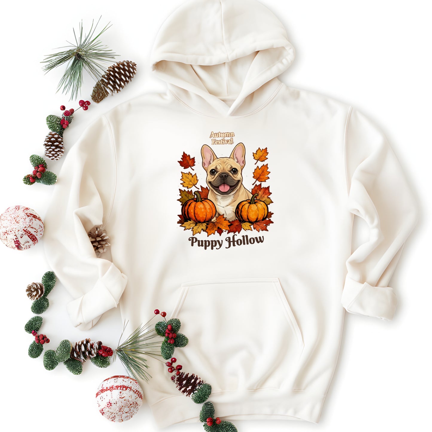 White hoodie with a dog graphic and 'Puppy Hollow' text, surrounded by autumn decorations on a white background.
