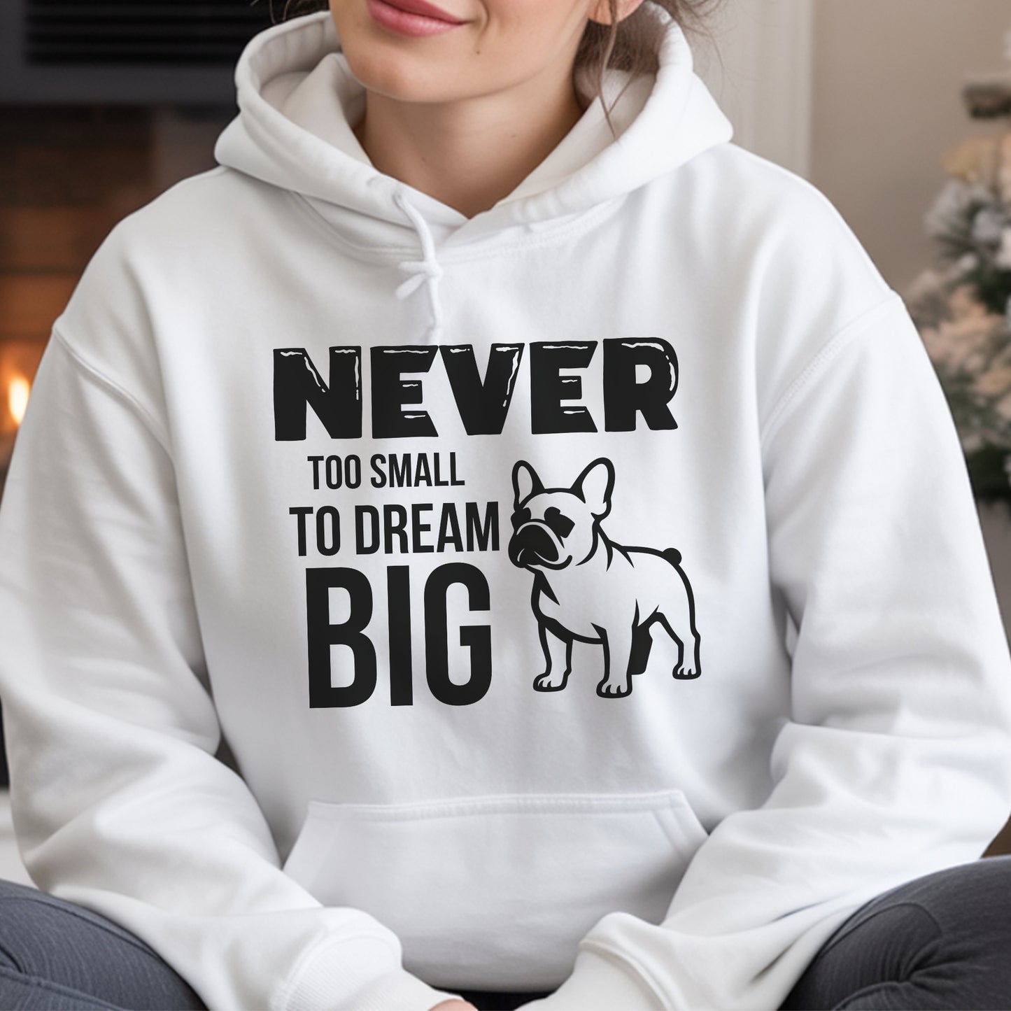 White hoodie with motivational text and dog illustration worn by a person.