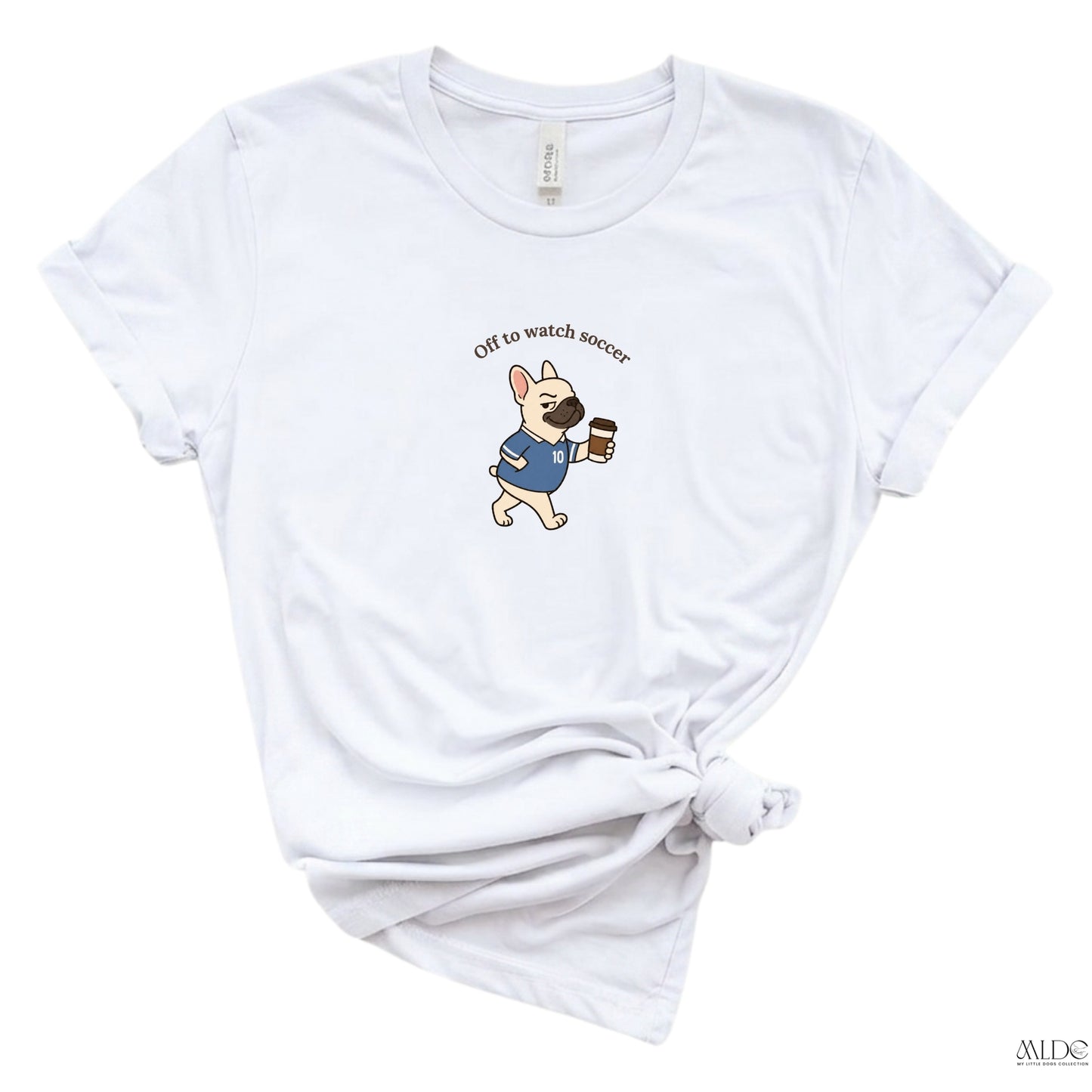 White t-shirt with a dog graphic and text 'Off to watch soccer' on a white background