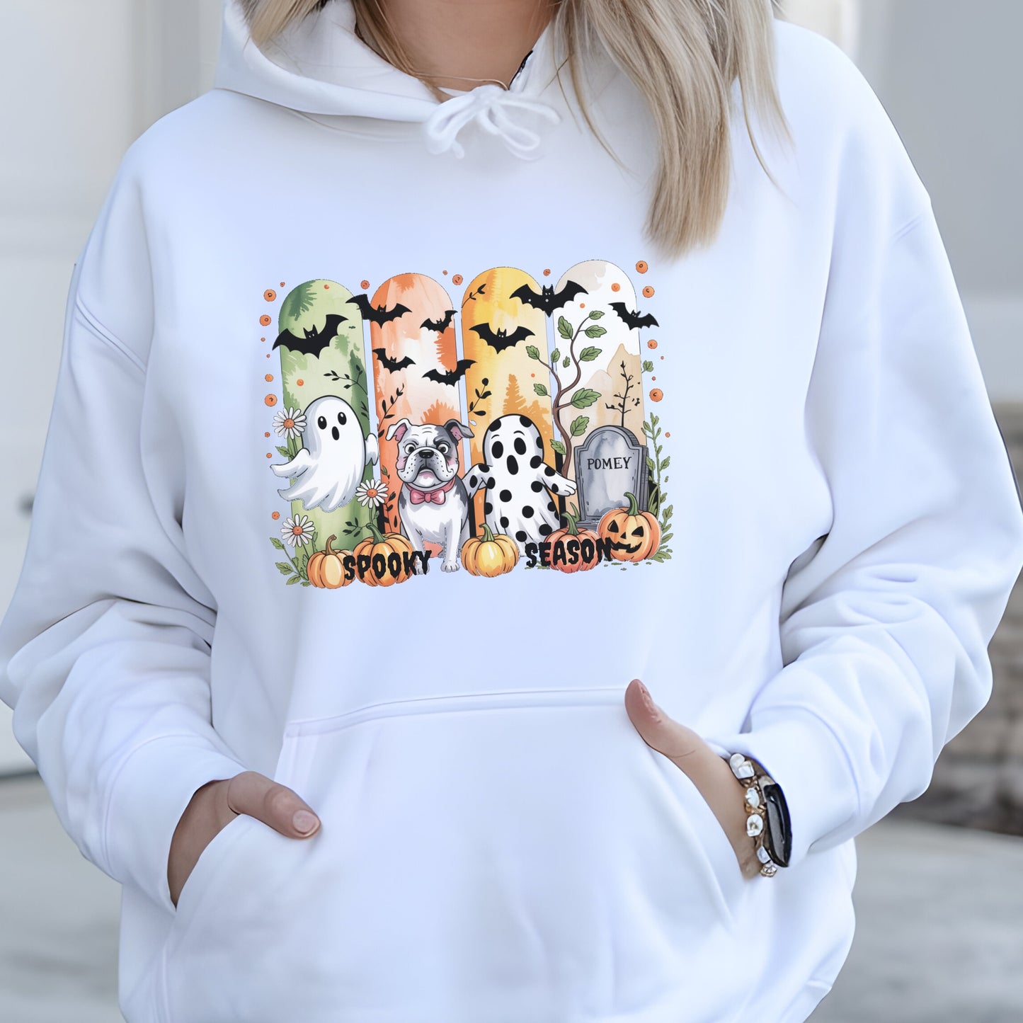 White hoodie with Halloween-themed print of small dogs in ghost costumes, bats, pumpkins, and “Spooky Season” text on the front.
