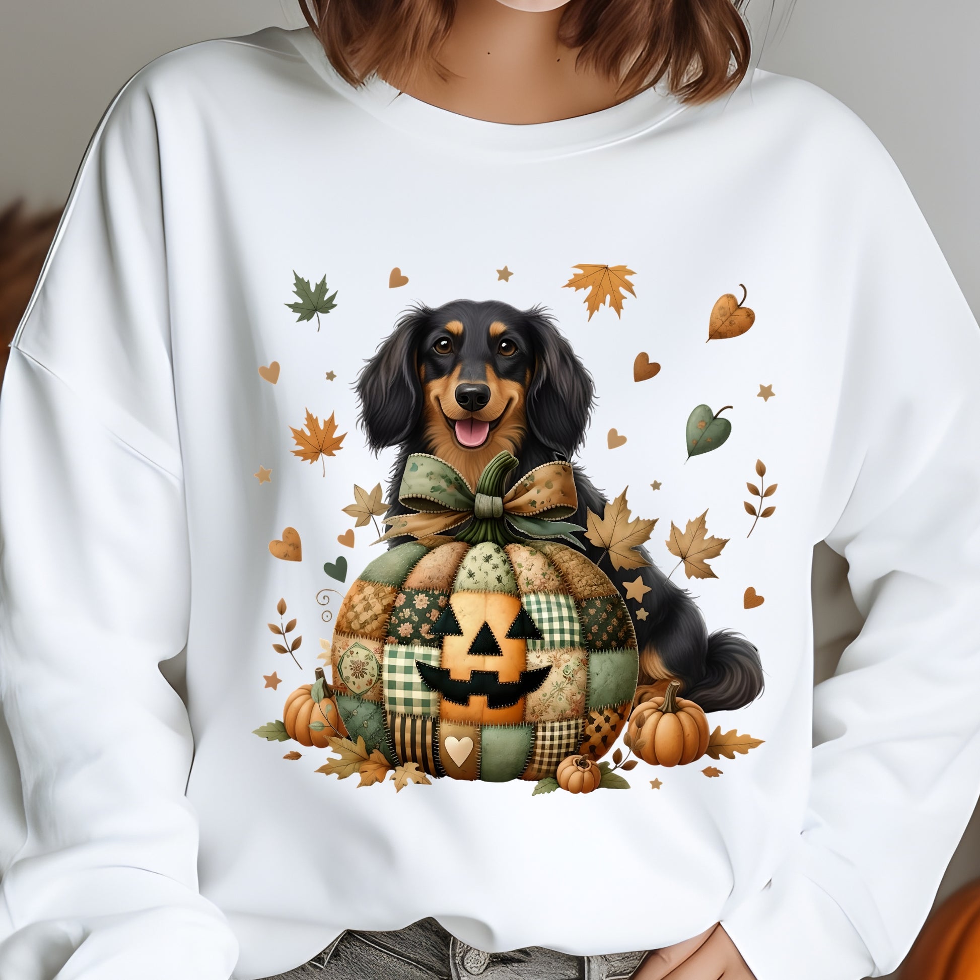 White sweatshirt with a dog and pumpkin design, featuring autumn leaves and pumpkins.