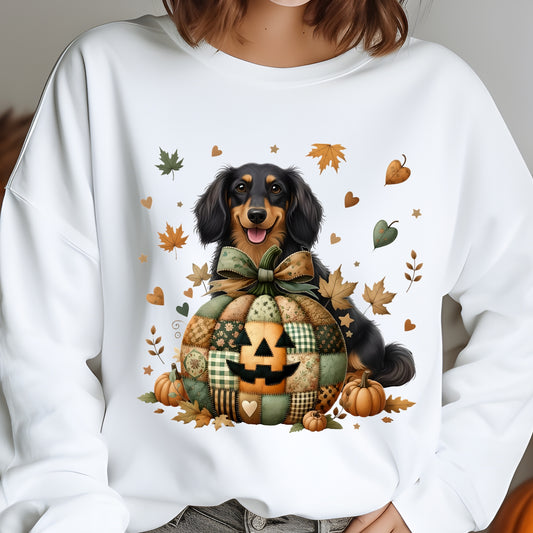 White sweatshirt with a dog and pumpkin design, featuring autumn leaves and pumpkins.