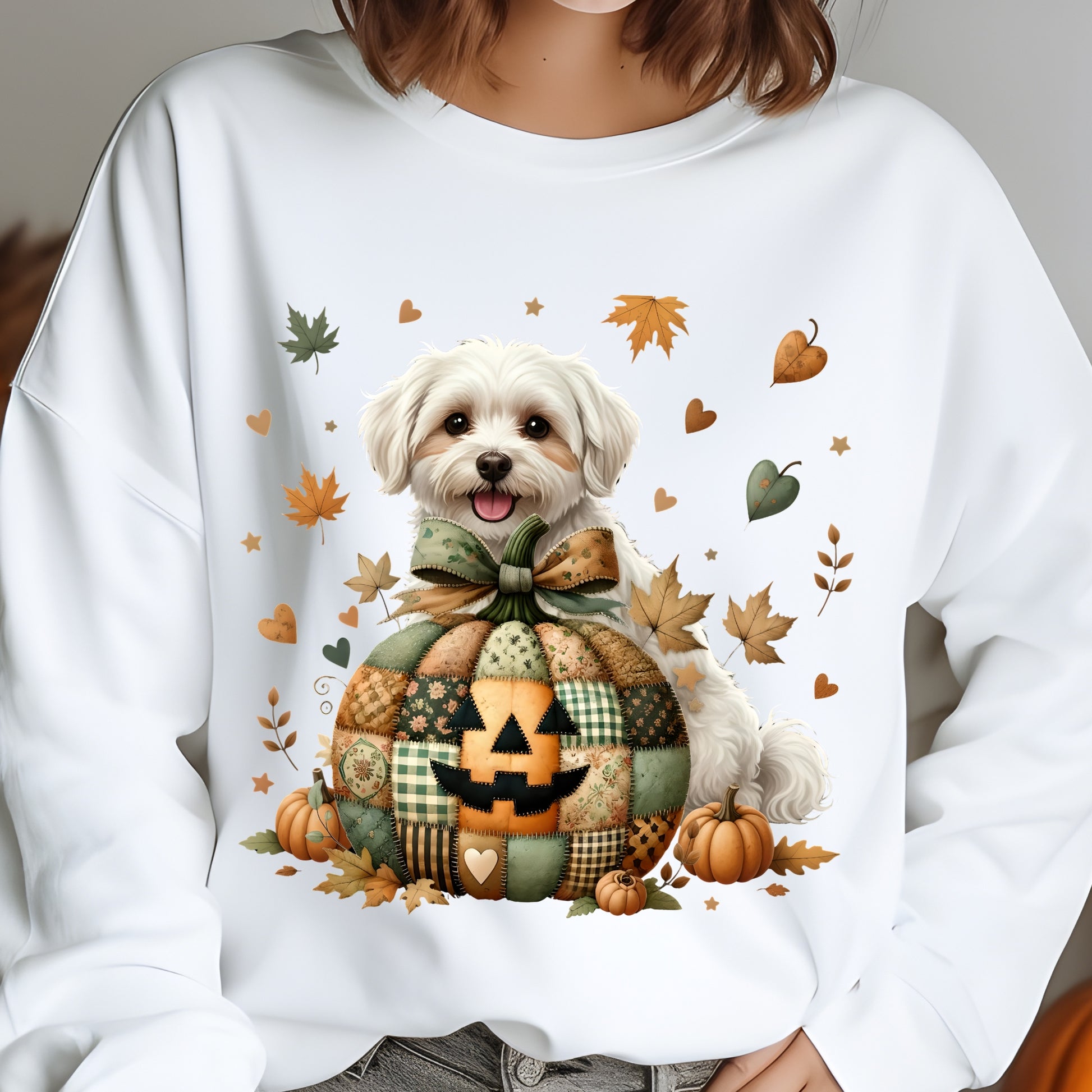 White sweatshirt with a dog and pumpkins design, worn by a person.