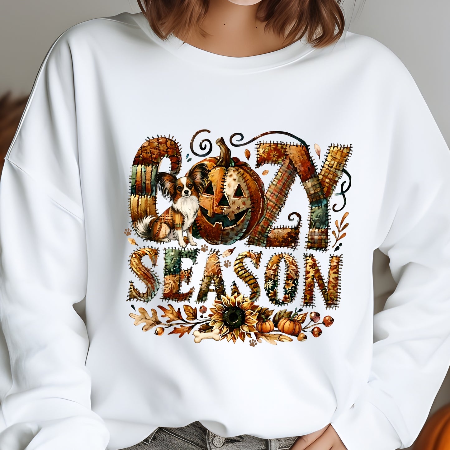 White sweatshirt with 'Cozy Season' design featuring pumpkins and a dog.
