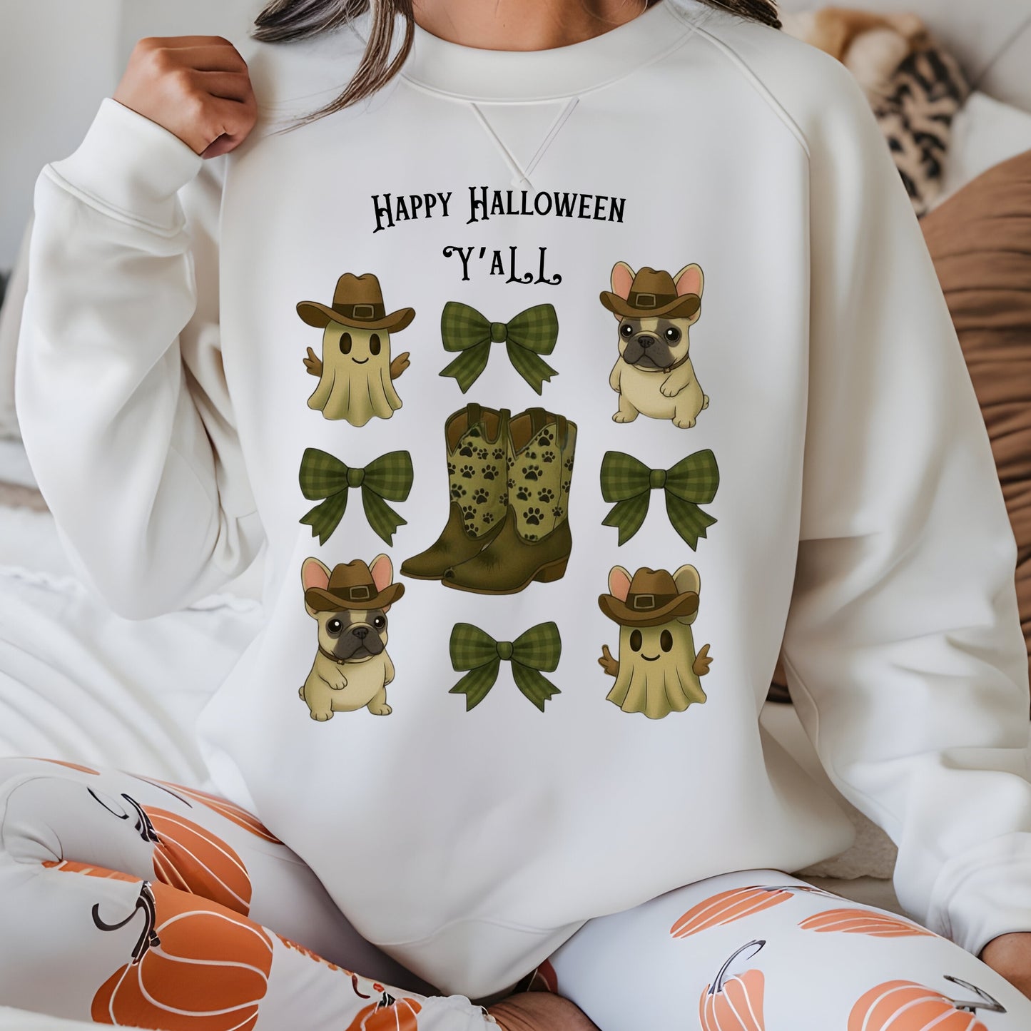 Person wearing a white sweatshirt with Halloween-themed graphics and text.