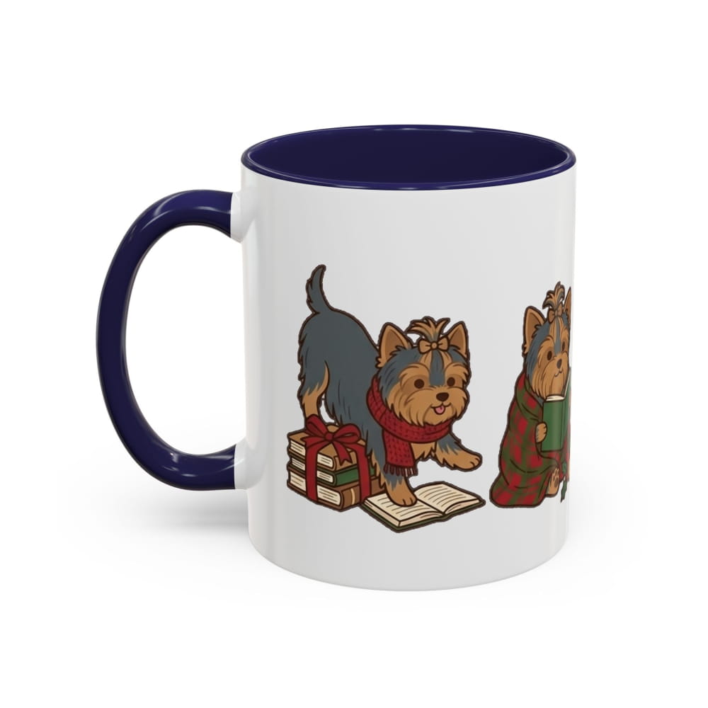 White ceramic mug with a navy interior and navy handle, showing a Yorkie in a red scarf beside wrapped gifts and an open book, and another Yorkie in a plaid blanket.